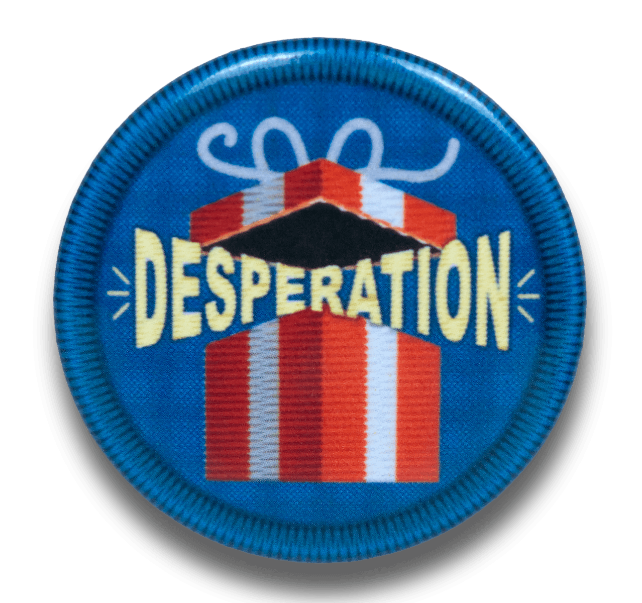 A blue metal pin designed like a scout badge depicting a gift box containing "Desperation"